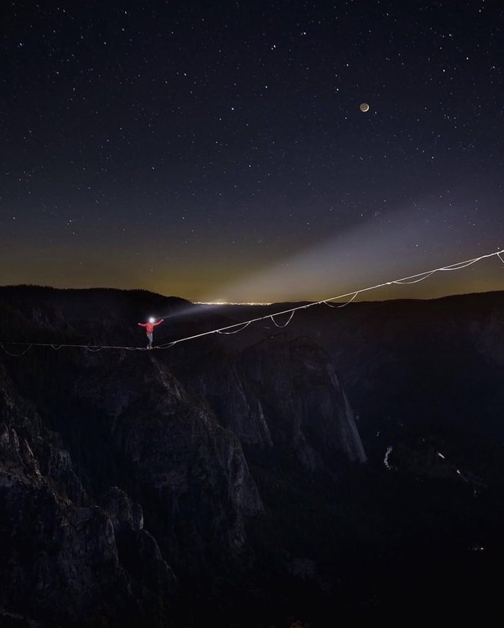 Highliner on a moonlit line under the stars