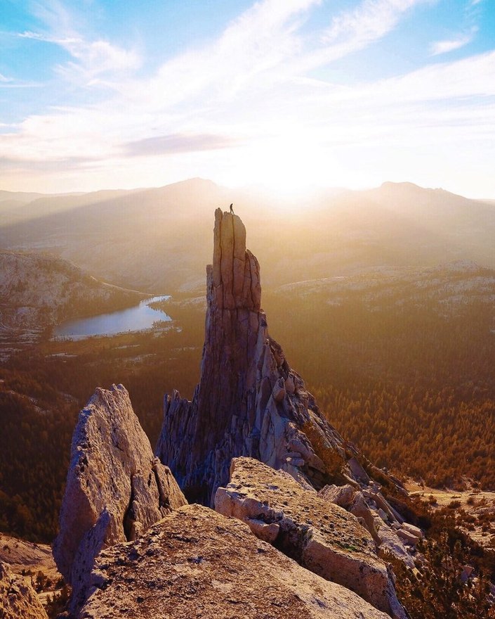 Standing atop a granite spire at sunset in the High Sierra