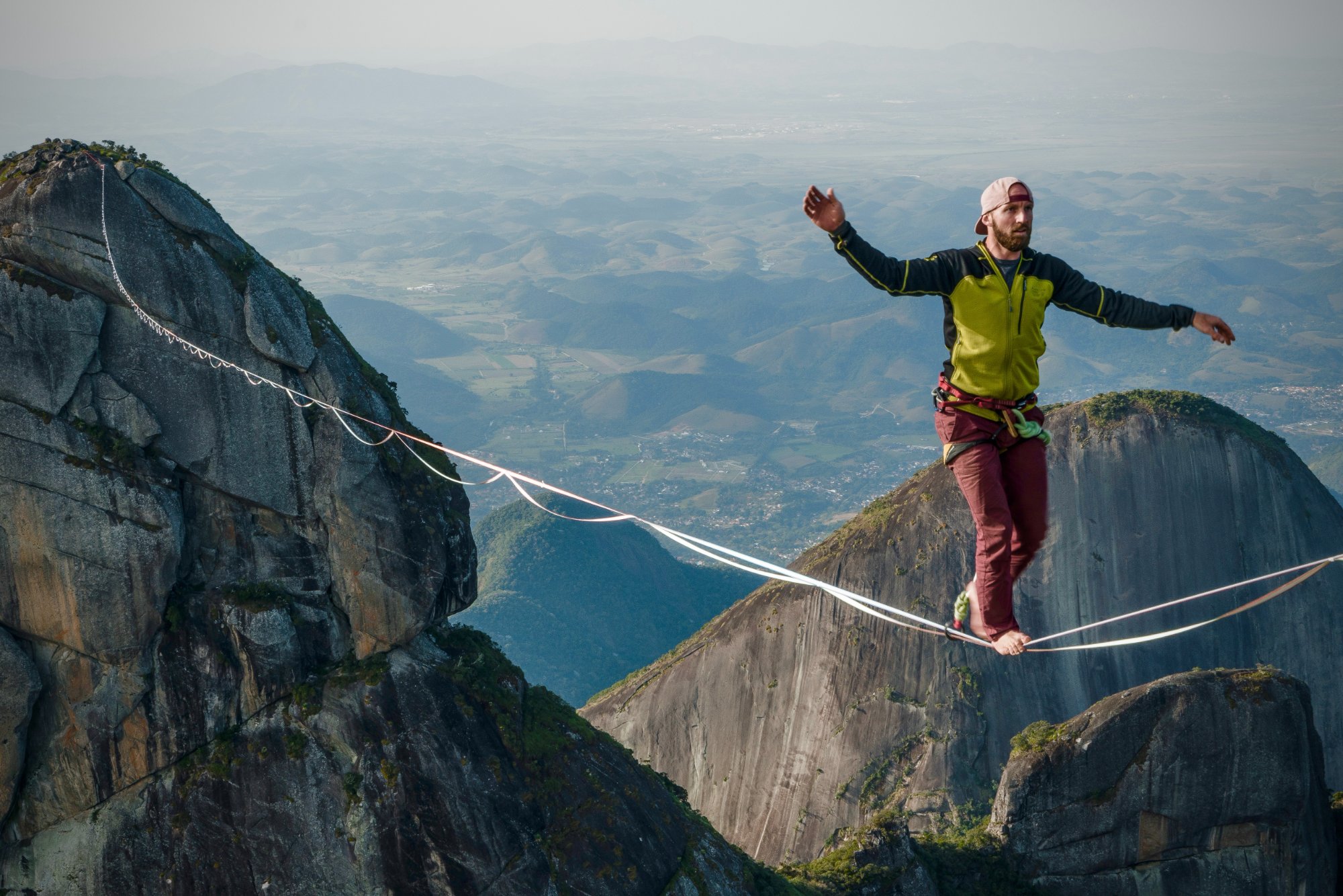 Ryan Robinson walking a highline between mountain peaks in Brazil