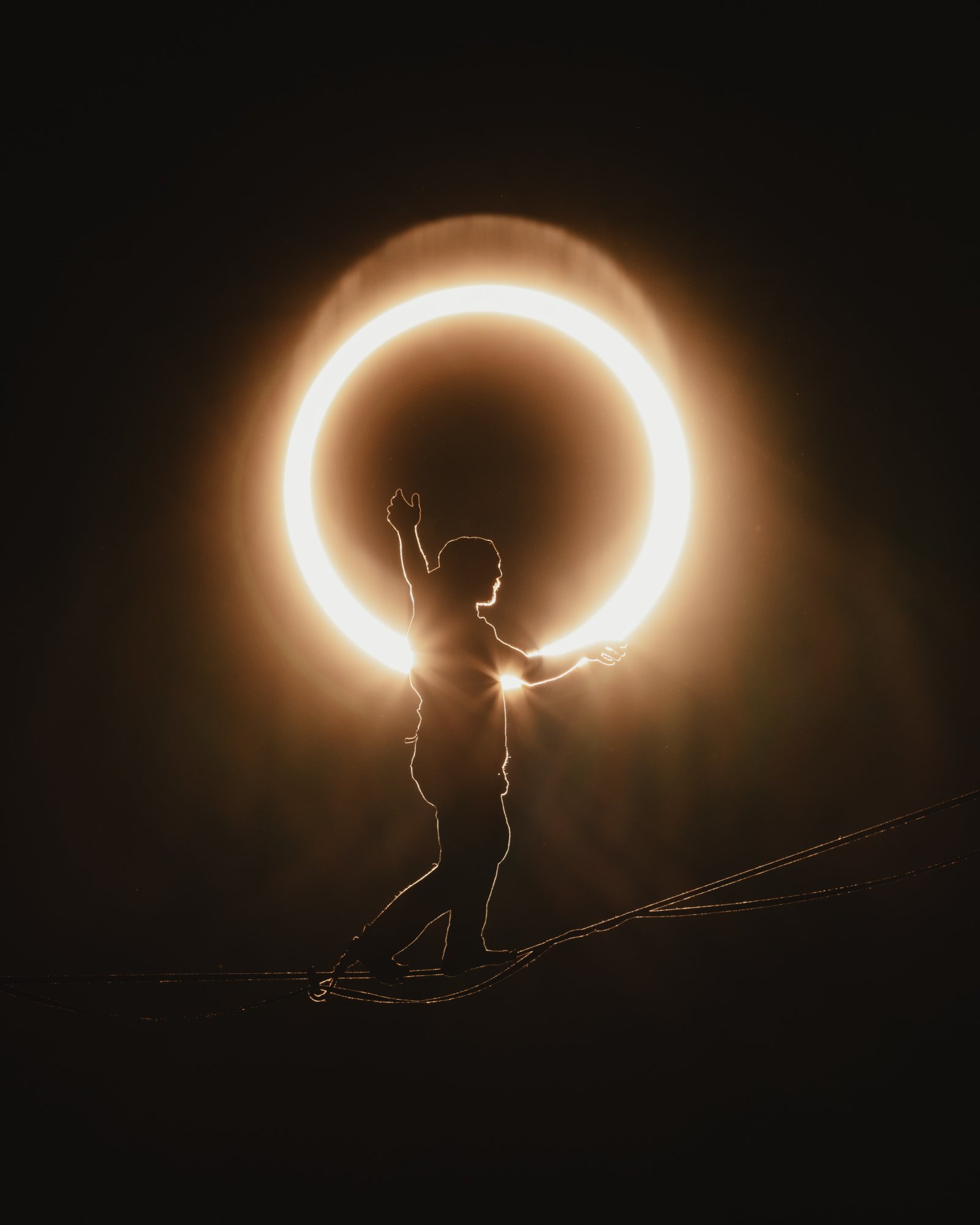 Ryan Robinson silhouetted against the supermoon on a highline