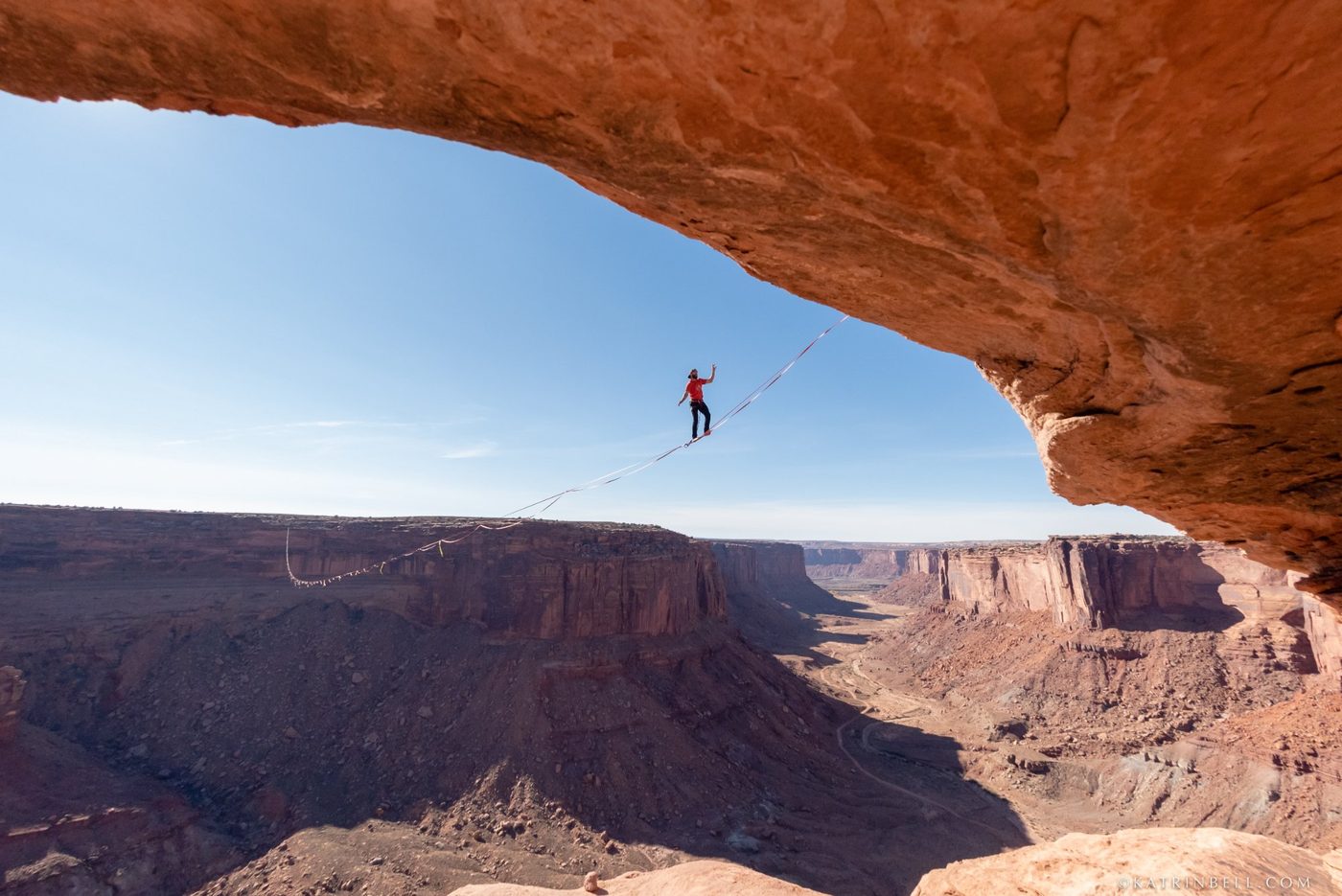 Highlining under a natural arch in Utah